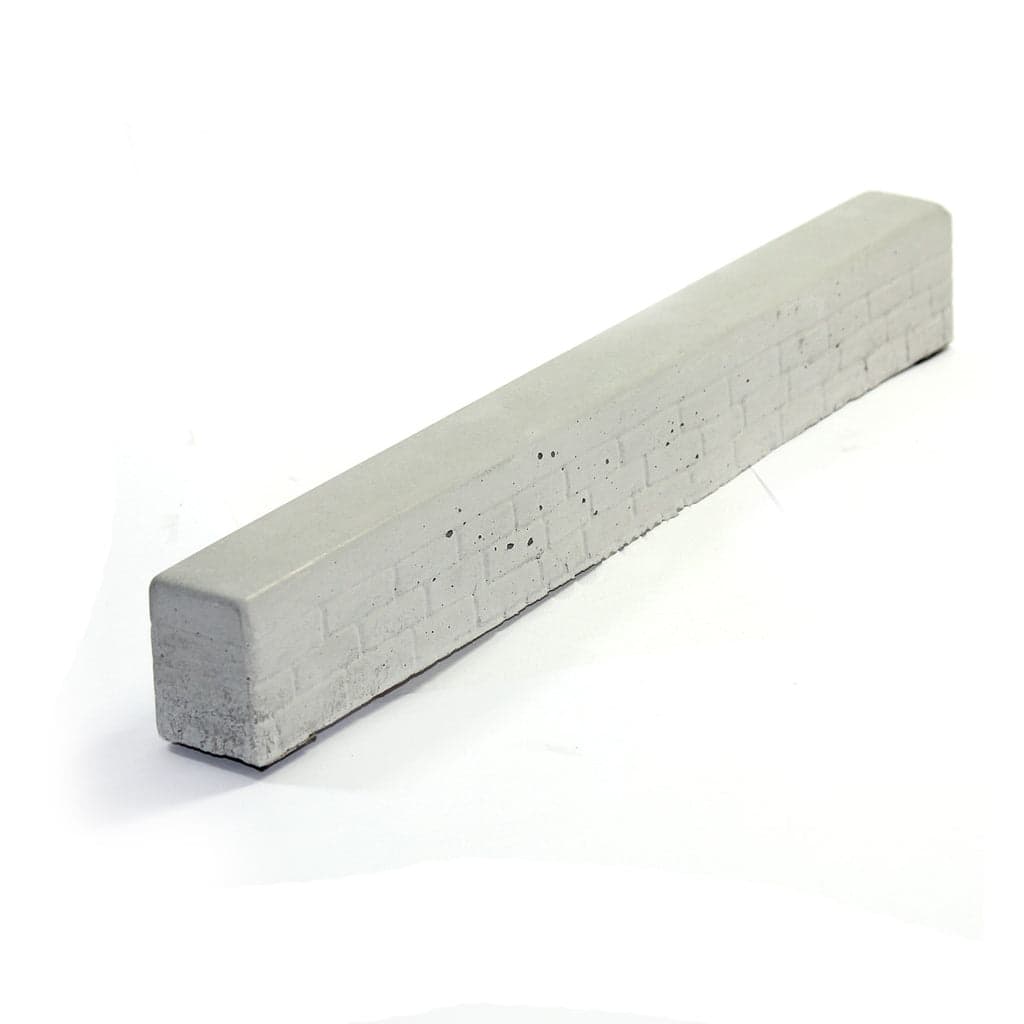 A long low Yellowood concrete mini wall fingerboard obstacle.