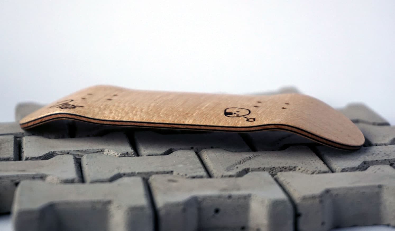 Side profile of a Prete 6011 fingerboard deck showing its medium kicks and concave.