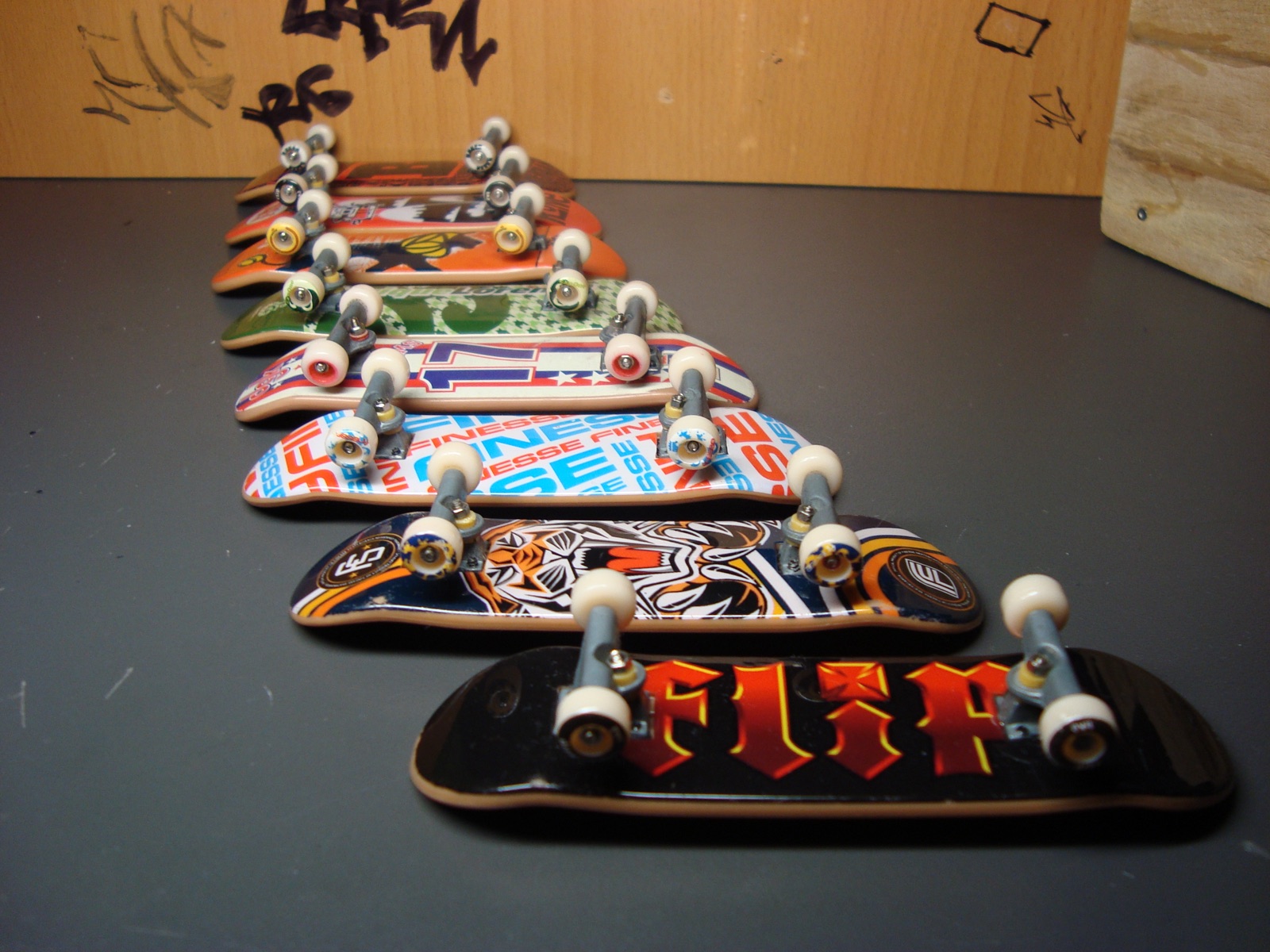 Several assembled fingerboards with different graphic decks arranged in a receding row.